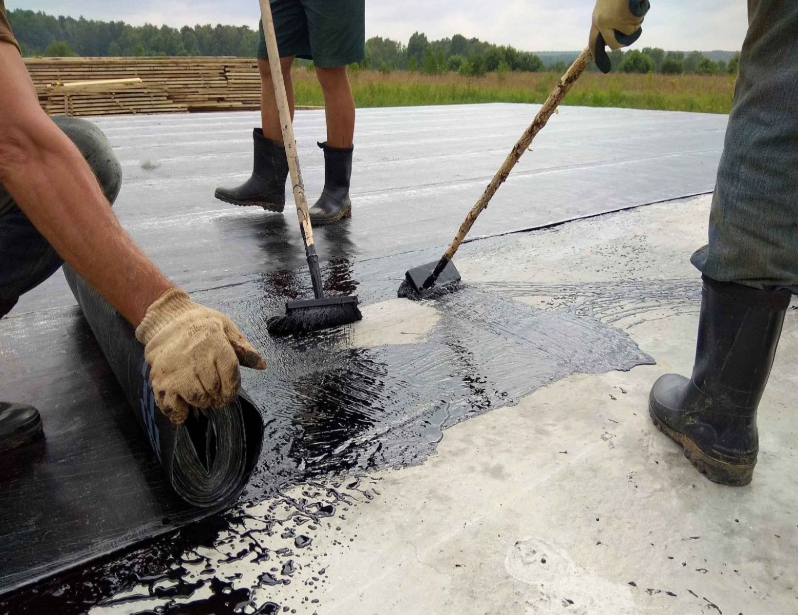 Close up of a worker drilling in a metal sheet onto a roof